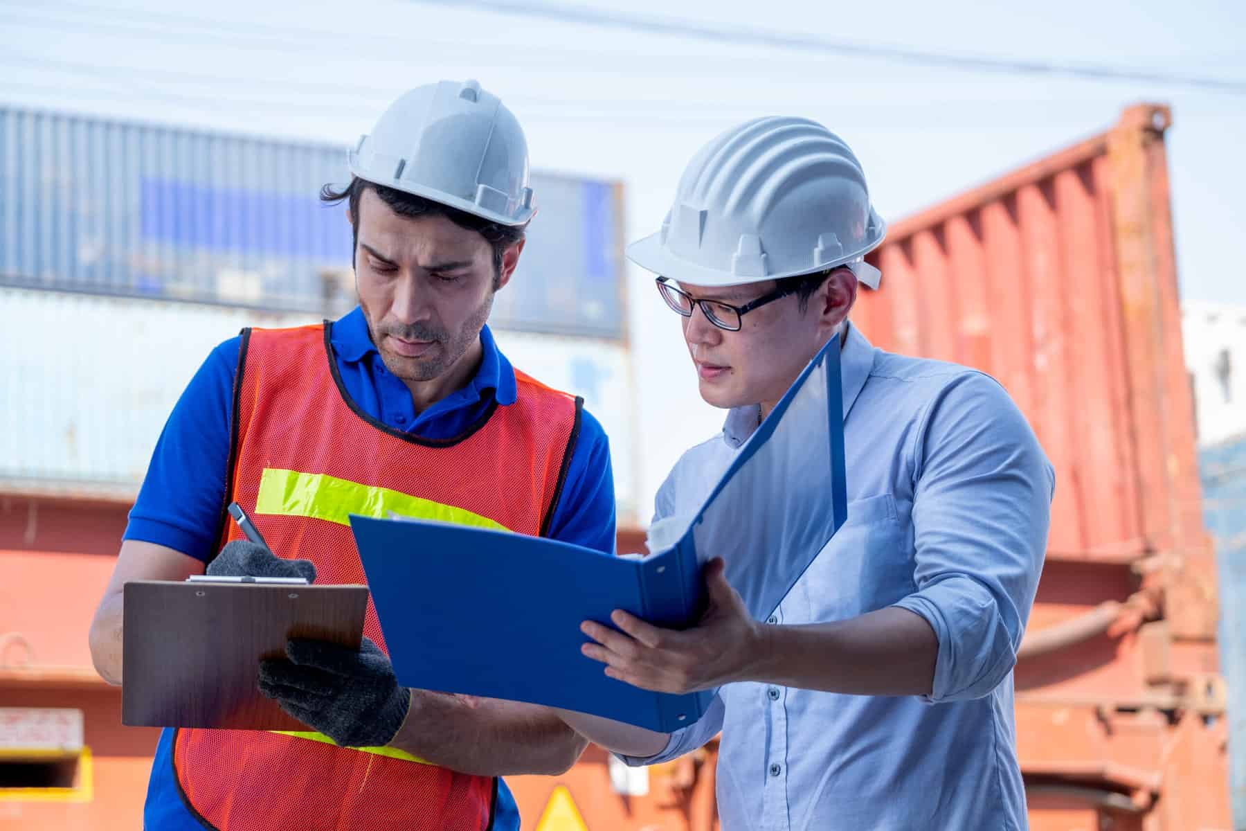 foreman and cargo container worker discuss togethe 2022 01 19 00 17 26 utc scaled